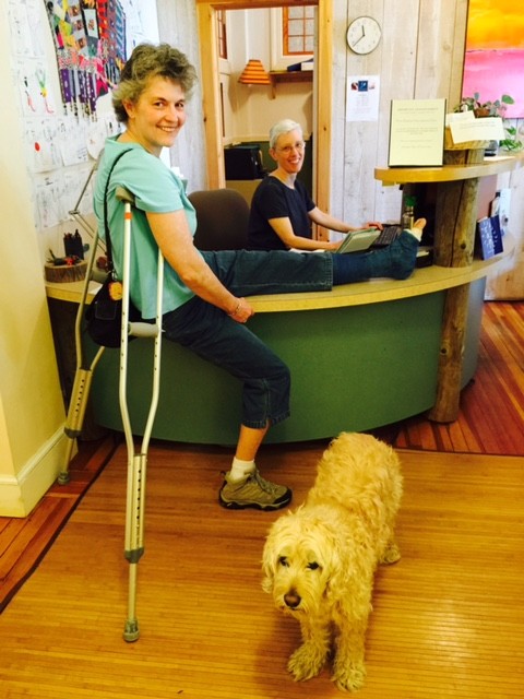 Kathryn and Arthur greet Karen at the front desk.